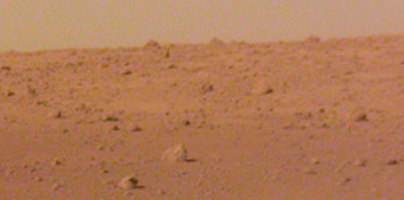 A zoomed-in view of the Elysium Planitia horizon, showing some rather large boulders in the background.